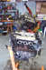 1995 Ford Taurus - Engine removal and rebuild in progress, with one engine on a stand and another being hoisted.