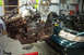 1995 Ford Taurus - Engine removal in progress for a 1995 Ford Taurus, showing the vehicle's engine bay and the detached engine.