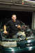 1995 Ford Taurus - Man poses in the engine bay of a 1995 Ford Taurus during an engine refresh or swap.