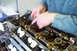 1995 Ford Taurus - Mechanic's hands performing maintenance on an engine's valve train components.