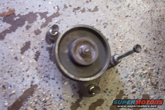 Pulley assembly with bolts on concrete floor