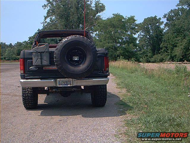 Black Ford Bronco with spare tire on rear, gas cans mounted, and license plate DJT-2871