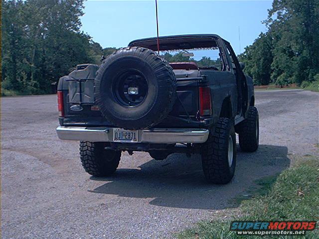 1986 Ford Bronco rear view with spare tire mounted on tailgate and two jerry cans