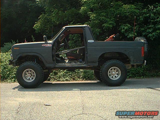 Modified 1980s Ford Bronco with doors removed, roll cage, and off-road tires