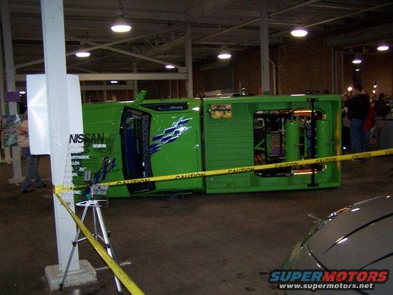 Green Nissan SEIBON vehicle on its side, showing internal components and custom graphics