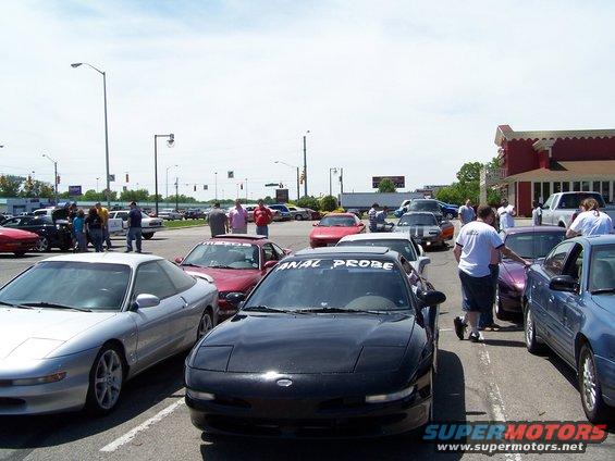 Several Ford Probe cars parked in a lot, one with 'ANAL PROBE' sticker on windshield