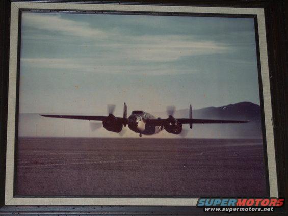 Twin-engine airplane in flight, front view