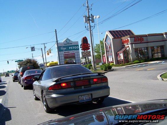 Gray coupe with a spoiler, seen from rear in traffic. License plate 548 4736