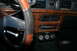 1989 Ford Crown Victoria LTD - The interior of a 1989 Ford Crown Victoria LTD shows wood grain accents, a stereo, and three auxiliary gauges.