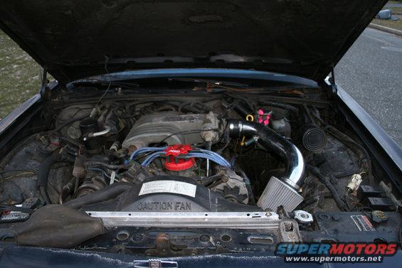 1989 Ford Crown Victoria engine bay with aftermarket air intake and red distributor cap