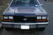 1989 Ford Crown Victoria LTD - The front of a Ford Crown Victoria shows a black grille and chrome bumper with a license plate.