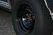 1989 Ford Crown Victoria LTD - Close-up of a car's wheel and tire, showing a black steel rim and chrome body trim.