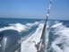 1979 Ford F-250 - A fishing rod and Yamaha outboard motor are visible as a boat speeds through the ocean, leaving a foamy wake.