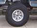 1988 Ford Pickup - Detail shot of the wheel and suspension system on a 1988 Ford Pickup truck.