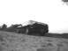 1995 Ford Probe - Rear view of a black 1995 Ford Probe parked on a dirt road.