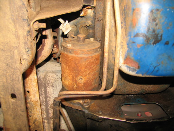 Rusty fuel filter and engine components under a vehicle