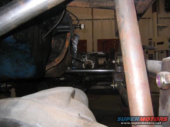 Close-up of engine block, exhaust pipe, and suspension components