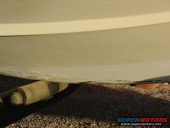 Close-up of a white boat hull resting on a trailer roller