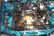 1995 Ford Taurus - The engine bay of a green vehicle, with most components and wiring removed, revealing the empty space where the engine once was.