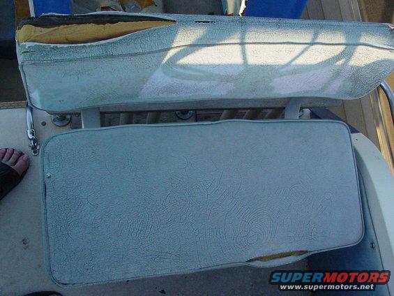 Worn light blue boat seats with torn upholstery