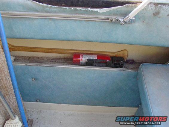 Boat interior with paddle and red fire extinguisher