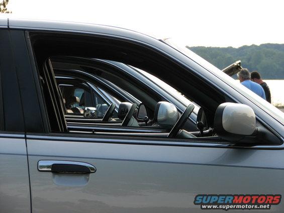 Side view of silver 2003 Ford Crown Victoria sedans parked in a row
