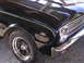 1963 Ford Ranchero - Close-up of a 1963 Ford Ranchero fender emblem and chrome trim.