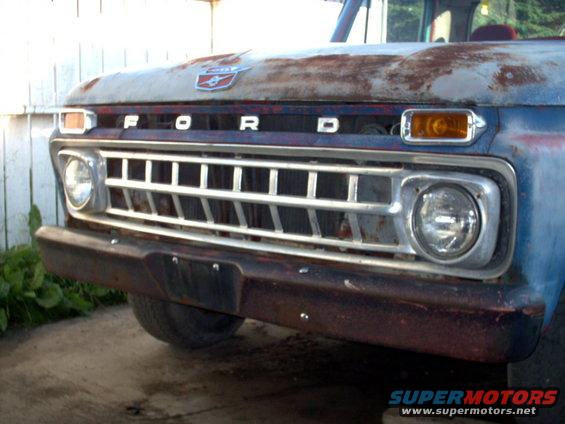 1965 Ford F-100 grille and hood, showing rust and blue paint