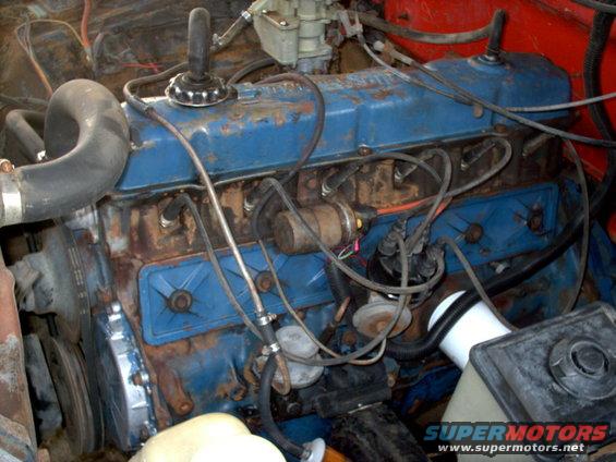 Blue engine with rust and visible spark plug wires