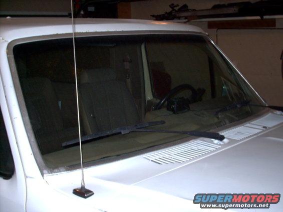 Front interior of a white Ford Bronco, showing seats, steering wheel, and windshield