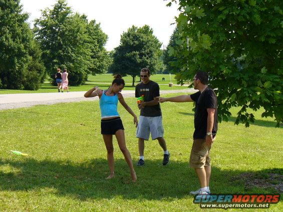 People playing in a park with water guns