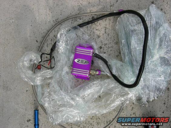 Purple ZEX nitrous oxide system component with hoses and wiring, wrapped in plastic