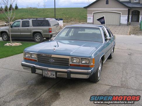 1988 Ford Crown Victoria LTD parked in driveway, another SUV in background