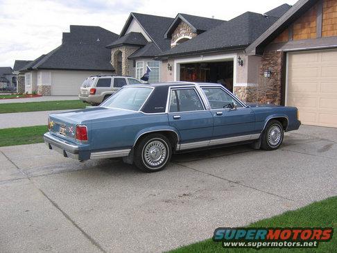 Blue 1988 Ford Crown Victoria LTD parked in driveway, rear quarter view