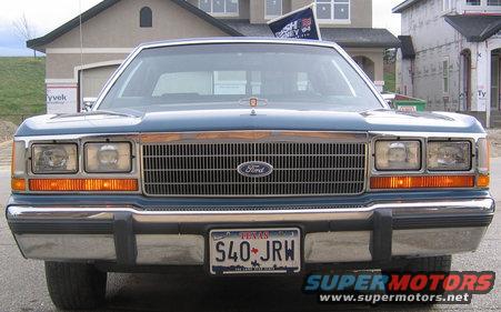 Front view of a blue 1988 Ford Crown Victoria LTD with a chrome grille and Texas license plate