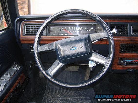 1988 Ford Crown Victoria LTD interior with wood trim, blue dashboard, and a Ford steering wheel