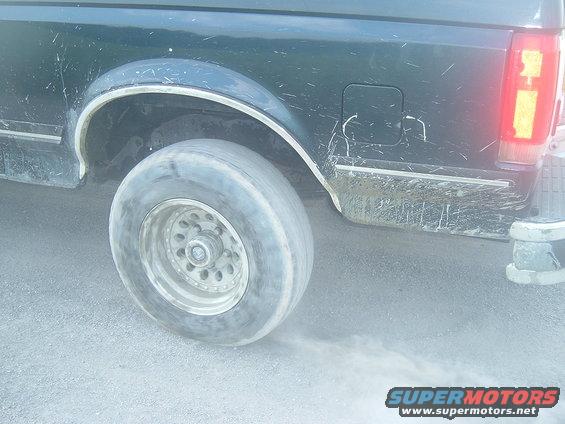 1988 Ford Bronco rear wheel kicking up dust