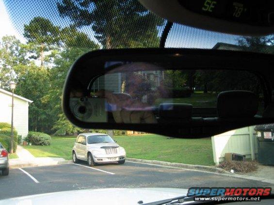 Silver Chrysler PT Cruiser parked in a lot, seen from inside another vehicle