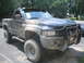 1990 Ford Bronco - This pickup truck is covered in mud, suggesting it has been off-roading.