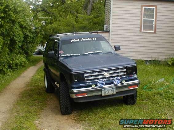 Blue Chevrolet S-10 Blazer with off-road tires and 'Mud Jamboree' banner