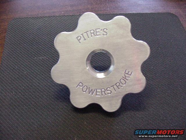 Metal part with text 'PITRE'S POWERSTROKE' engraved on it