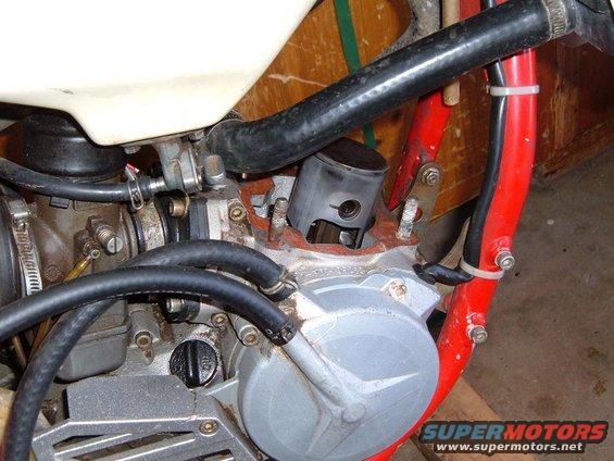 Close-up of a motorcycle engine's cylinder and carburetor assembly
