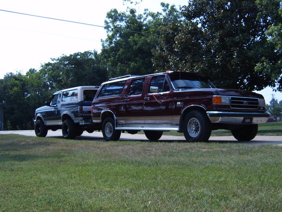 Maroon Bronco and a blue Bronco parked side-by-side