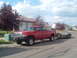 1996 Dodge 2500 - A red 1996 Dodge 2500 pickup truck is parked on a residential street, hitched to a dual-axle trailer.