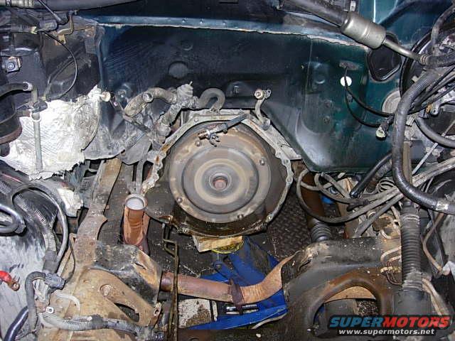 Engine bay with transmission bell housing and exhaust manifold