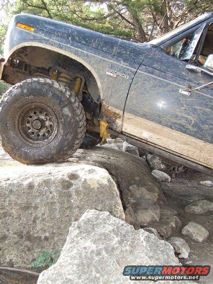 Dark blue 1986 Ford Bronco navigating rocky terrain
