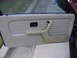 1984 BMW 3 Series - Close-up of a car's interior door panel, showing the armrest and handle.