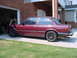 1984 BMW 3 Series - Maroon 1984 BMW 3 Series coupe with aftermarket wheels parked outside a garage.