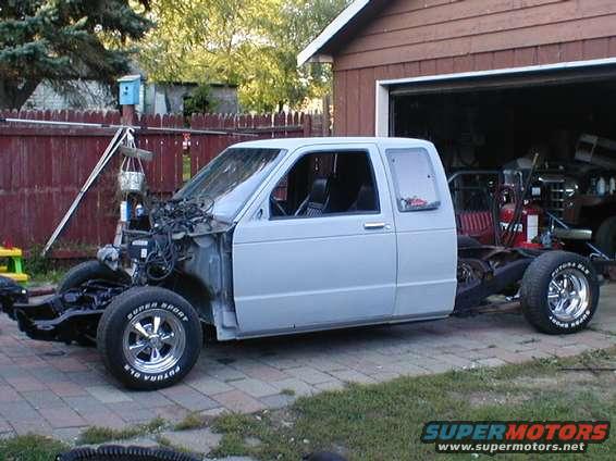White pickup truck chassis, front end removed, side view