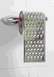 1978 Ford F-250 - A cheese grater repurposed as a toilet paper holder, mounted on a tiled wall.